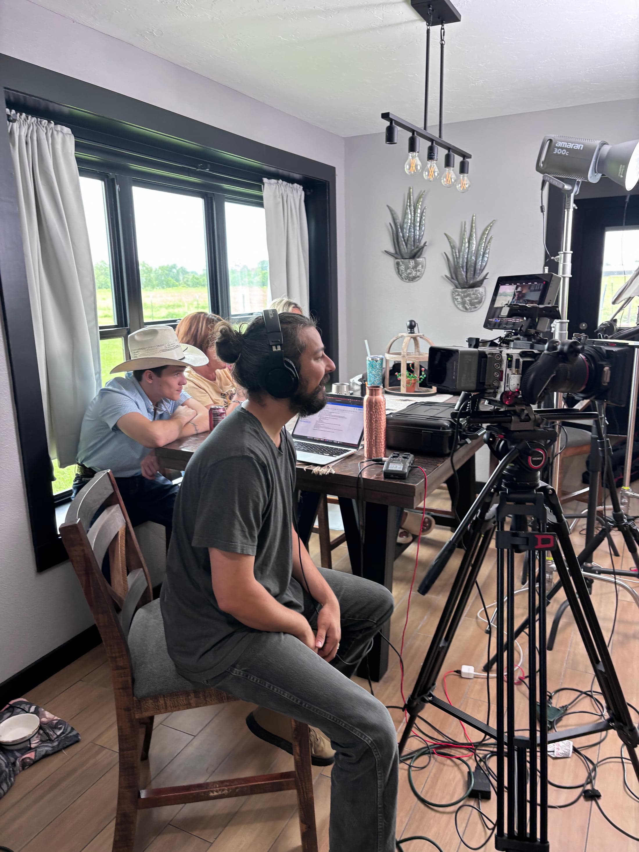 Nick Garza seated beside the camera, listening during an interview setup